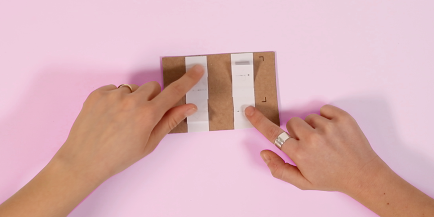 Two hands using an Interface made out of Paper